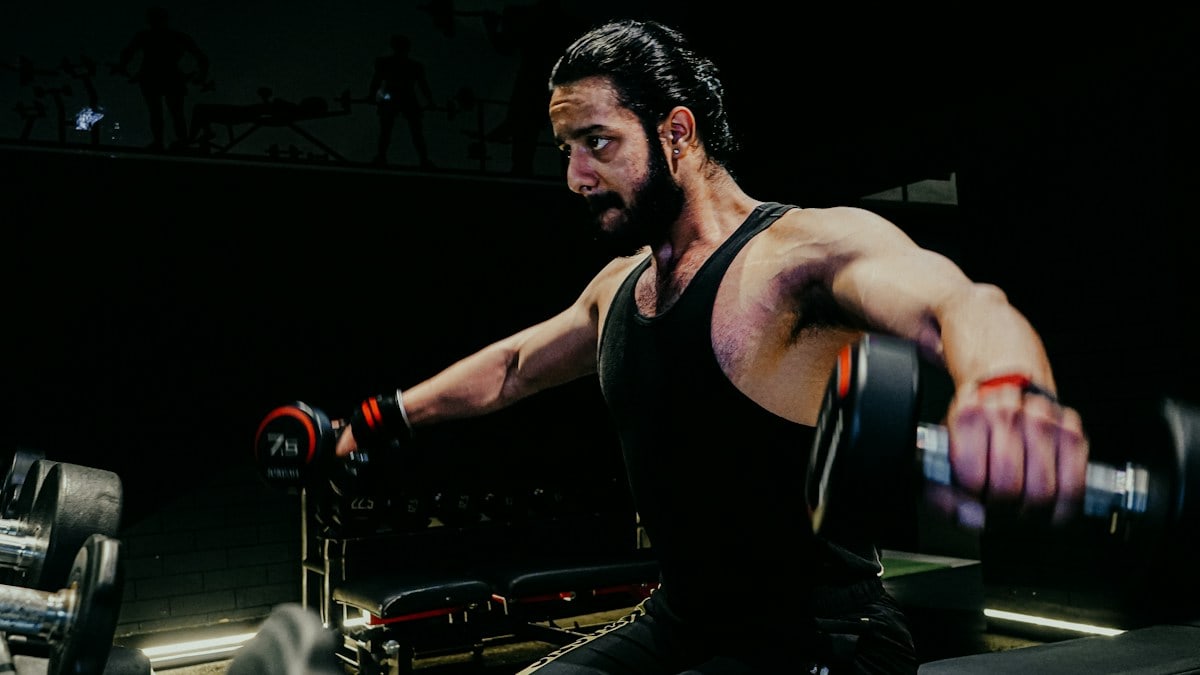a man with a barbell in a gym